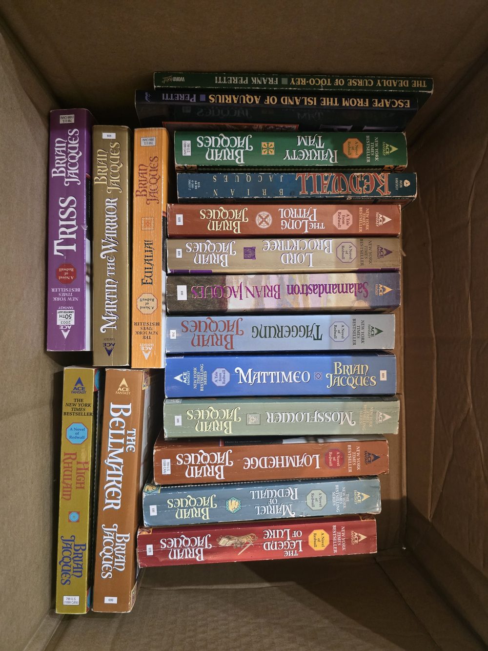 A cardboard box of well-worn Redwall paperbacks